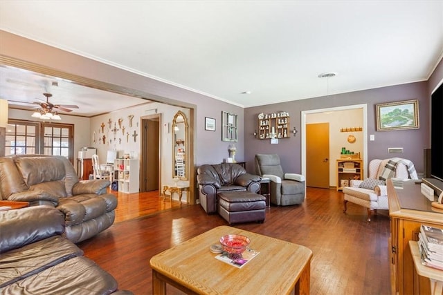 living room featuring dark hardwood / wood-style floors, ceiling fan, and ornamental molding