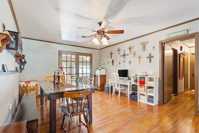 dining room with hardwood / wood-style flooring, ceiling fan, and crown molding