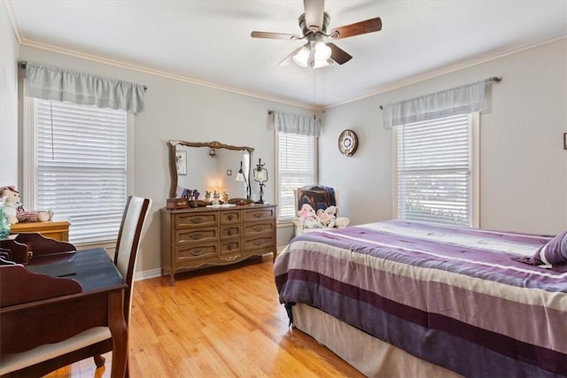 bedroom featuring light hardwood / wood-style flooring, ceiling fan, and crown molding