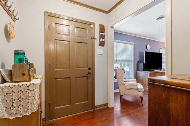 foyer featuring dark hardwood / wood-style flooring and ornamental molding