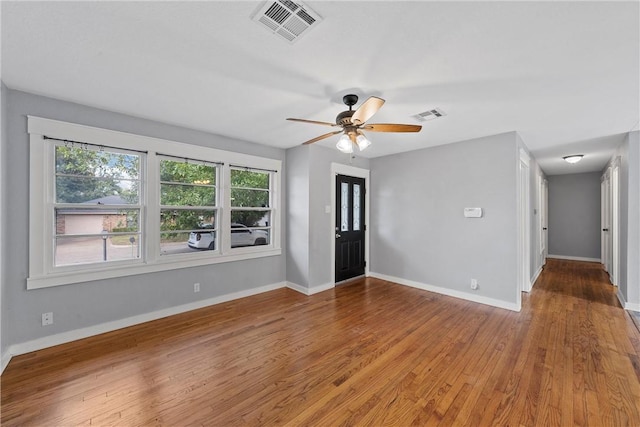 interior space with ceiling fan and wood-type flooring