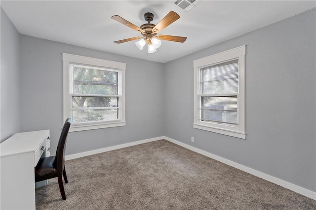 unfurnished office featuring carpet flooring and ceiling fan