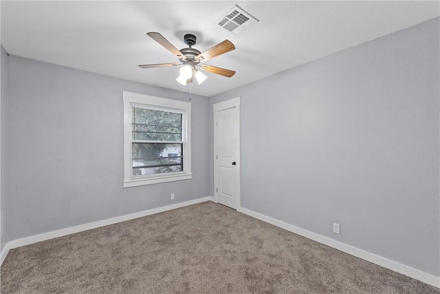 carpeted empty room featuring ceiling fan