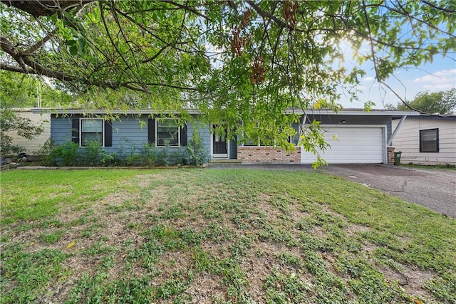 single story home with a front yard and a garage