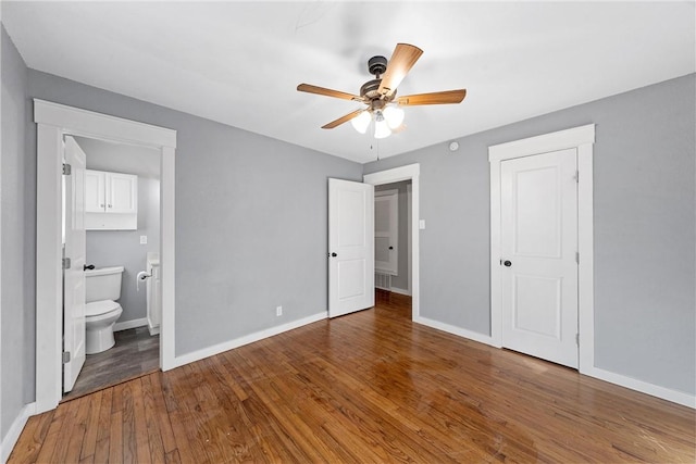 unfurnished bedroom with hardwood / wood-style floors, ceiling fan, and ensuite bath