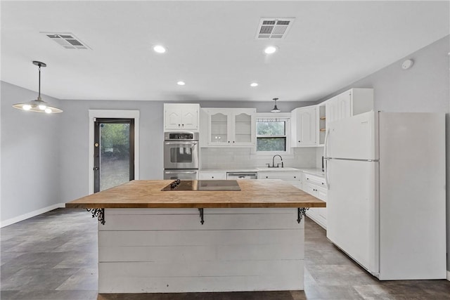 kitchen with stainless steel appliances, a kitchen island, and a wealth of natural light