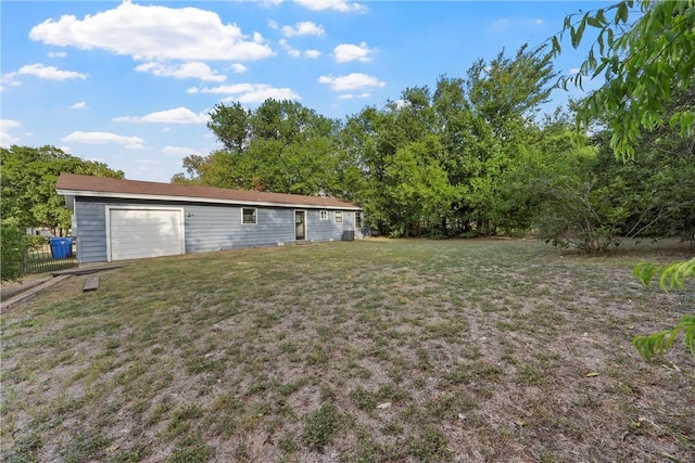 view of yard featuring a garage and an outbuilding