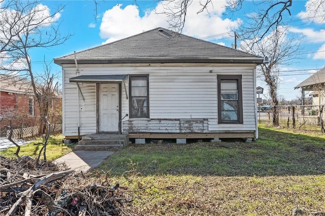 rear view of property with a lawn