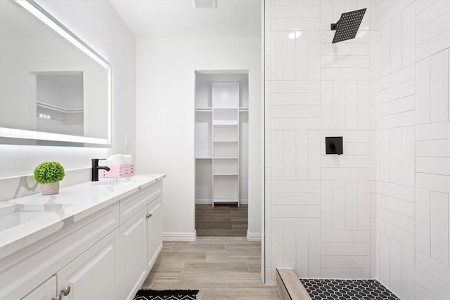 bathroom featuring vanity and tiled shower