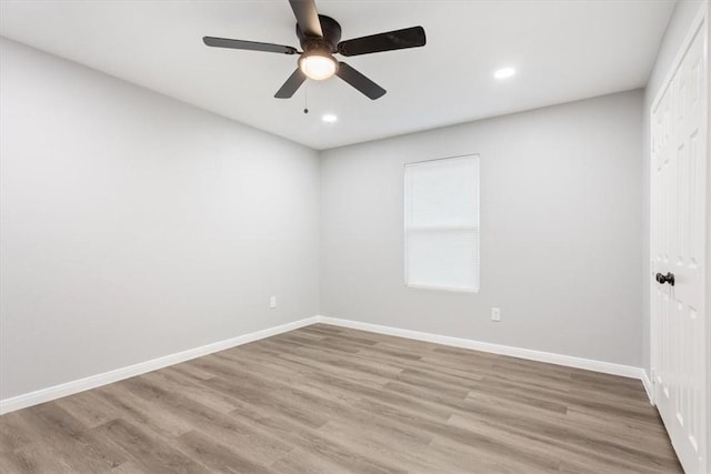 spare room featuring ceiling fan and light hardwood / wood-style floors