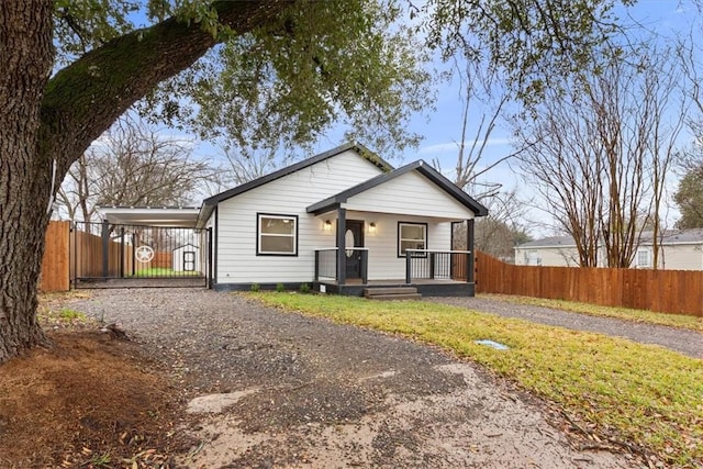 view of front of house featuring a carport and covered porch