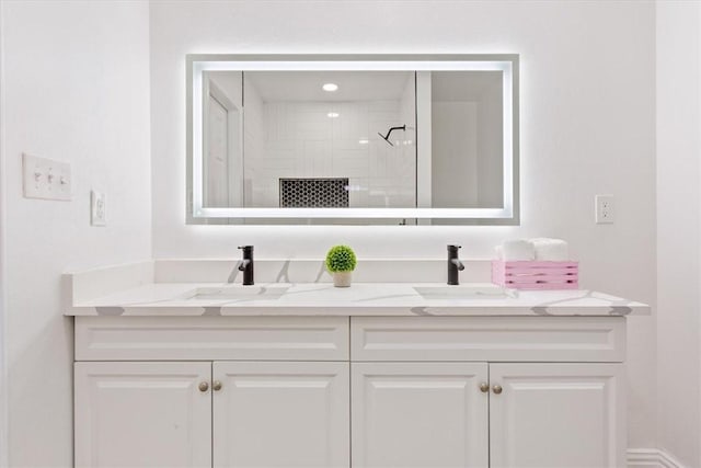 bathroom featuring a shower and vanity