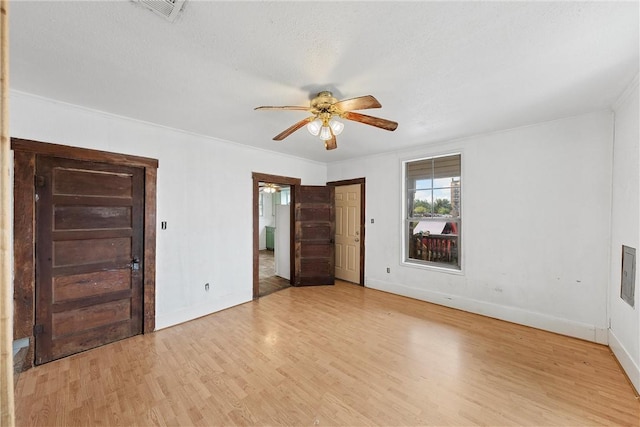 unfurnished bedroom featuring crown molding, ceiling fan, light hardwood / wood-style floors, and a textured ceiling