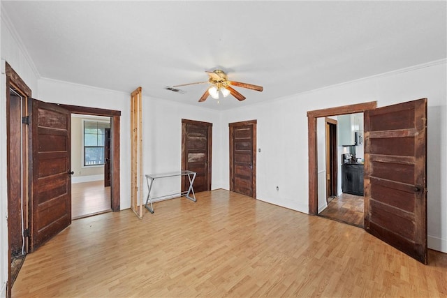 spare room with ceiling fan, ornamental molding, and light hardwood / wood-style floors