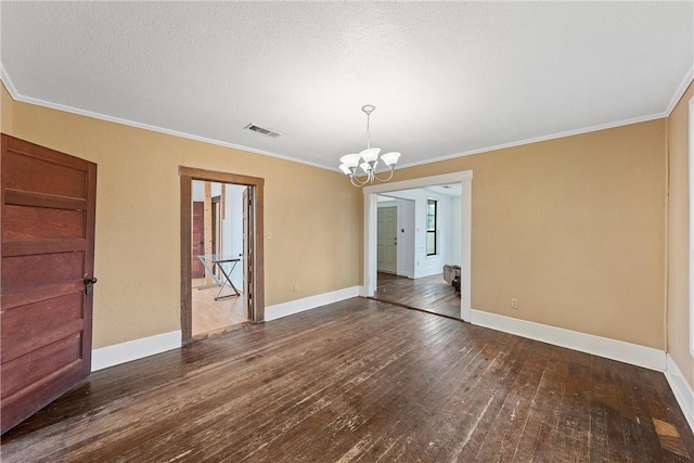 interior space with dark wood-type flooring, ornamental molding, an inviting chandelier, and a textured ceiling