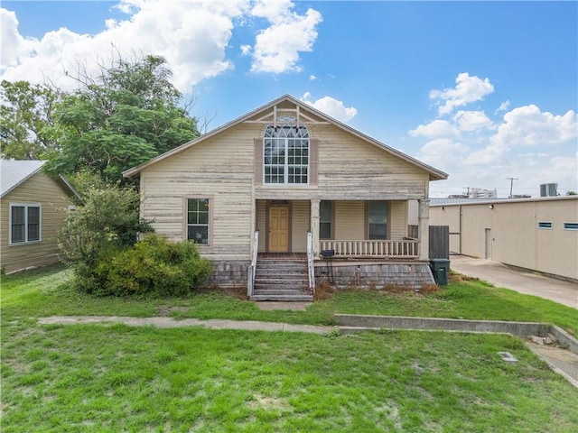 bungalow-style home featuring a porch and a front lawn