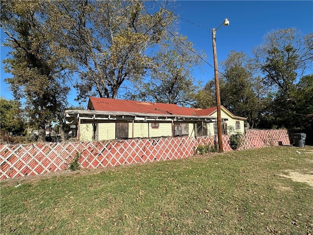 view of side of home featuring a yard