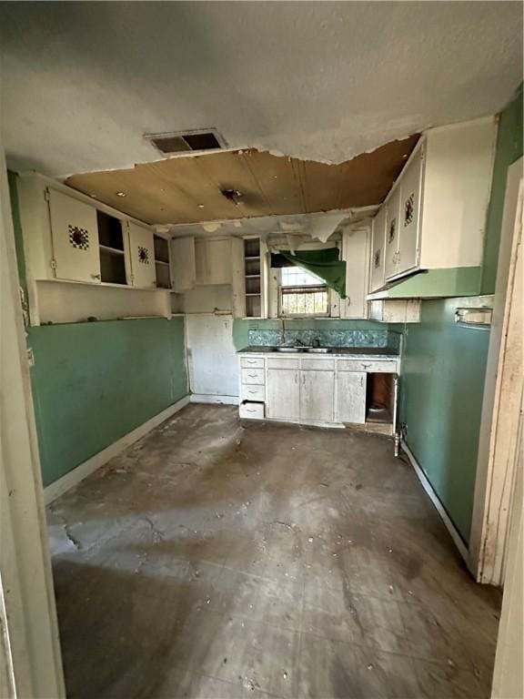 kitchen featuring white cabinets