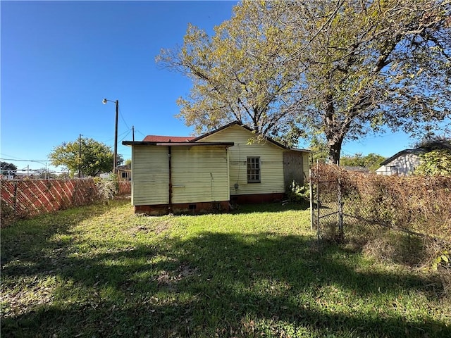 rear view of property with a lawn