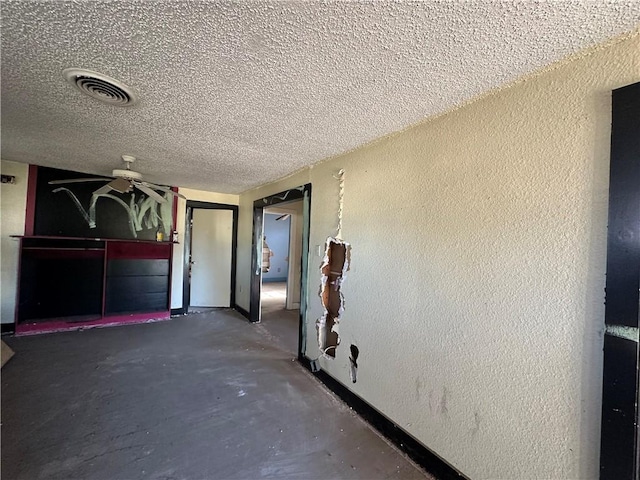 interior space with concrete flooring and a textured ceiling