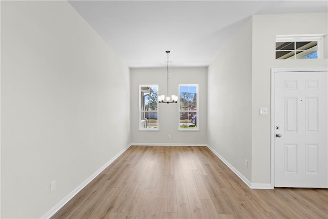 foyer featuring a chandelier and light hardwood / wood-style flooring