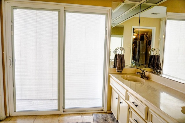 bathroom with tile patterned floors, plenty of natural light, and vanity