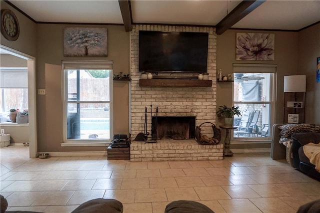 tiled living room featuring beamed ceiling and a brick fireplace