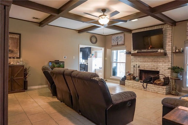 tiled living room with beamed ceiling, ceiling fan, coffered ceiling, and a brick fireplace