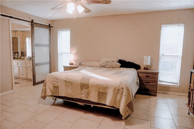 tiled bedroom with connected bathroom and ceiling fan