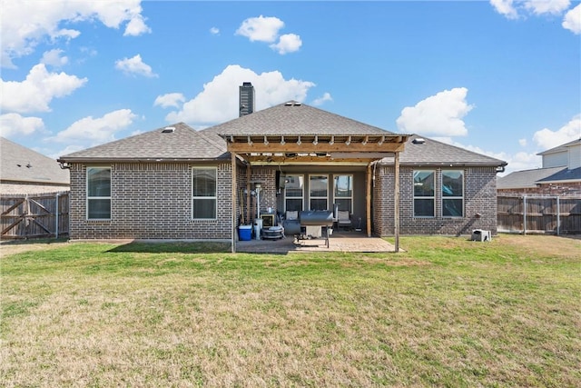 back of house featuring a lawn and a patio