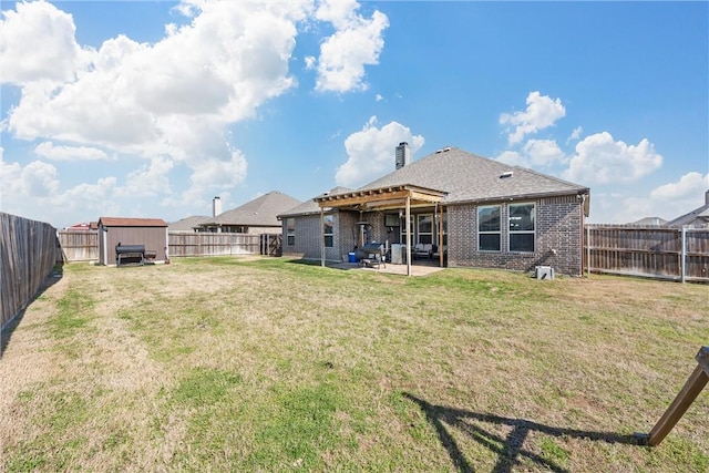 back of house featuring a patio area and a yard