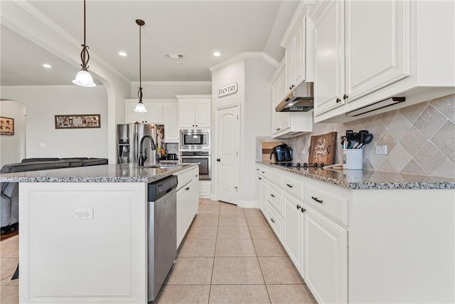 kitchen featuring a center island with sink, appliances with stainless steel finishes, stone counters, white cabinetry, and pendant lighting