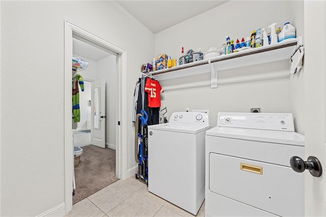 laundry room featuring light tile patterned floors and washer and clothes dryer