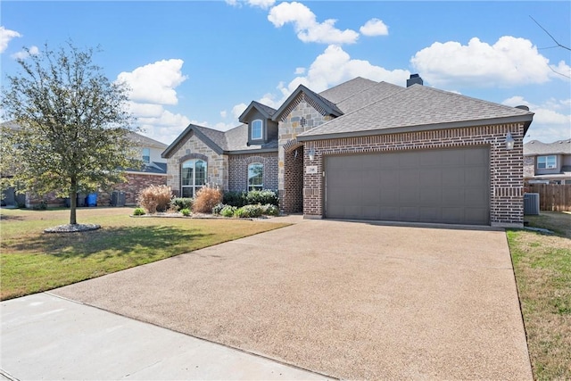 view of front facade featuring a garage, central AC unit, and a front yard