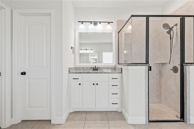 bathroom featuring vanity, tile patterned flooring, and a shower with shower door