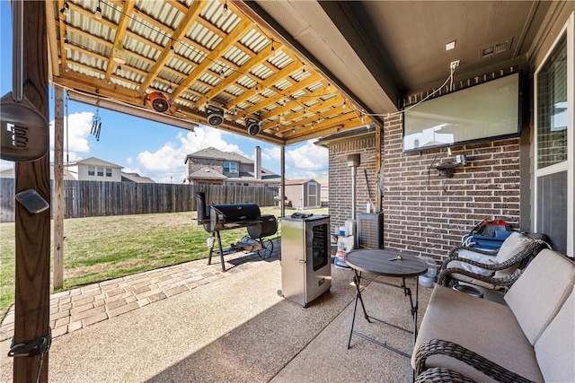 view of patio with a shed and a grill