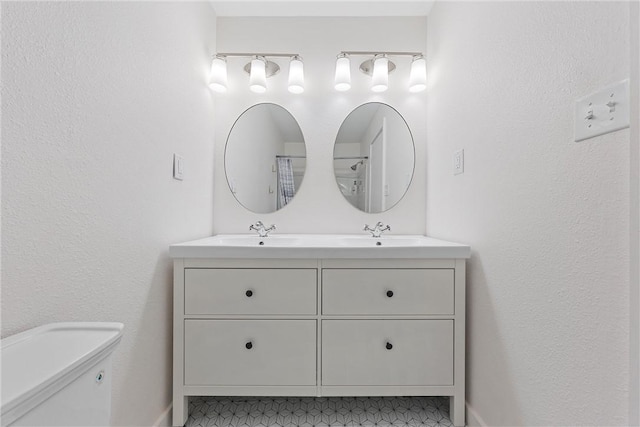 bathroom featuring vanity and toilet