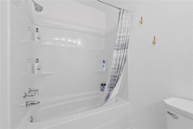 bathroom with shower / bath combo and toilet