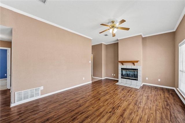 unfurnished living room featuring hardwood / wood-style flooring, ornamental molding, ceiling fan, and a fireplace