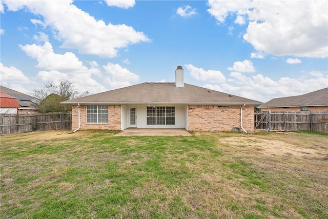 back of property with a patio and a lawn