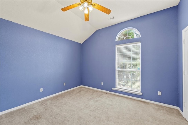 carpeted empty room with ceiling fan and vaulted ceiling