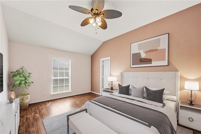 bedroom featuring vaulted ceiling, dark hardwood / wood-style floors, and ceiling fan