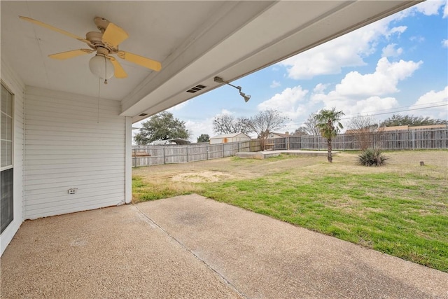 view of yard featuring ceiling fan and a patio area