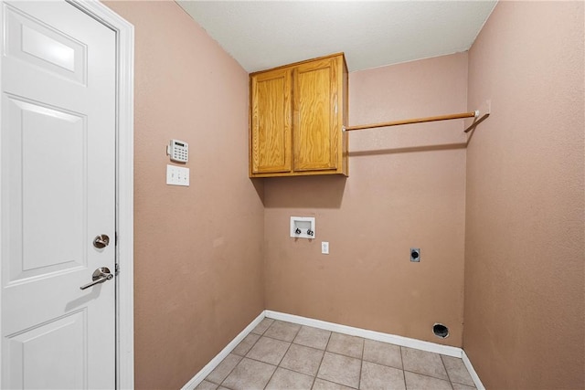 washroom with light tile patterned floors, hookup for a washing machine, cabinets, and hookup for an electric dryer