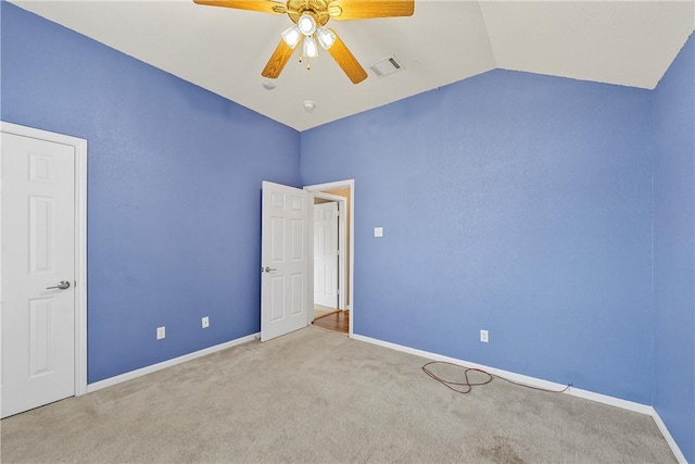 carpeted empty room featuring lofted ceiling and ceiling fan