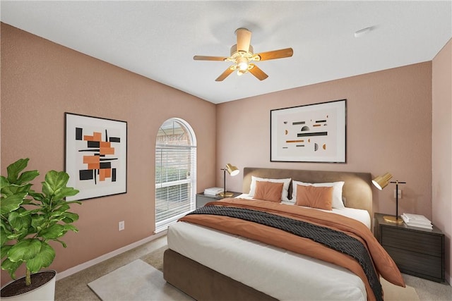 bedroom with light colored carpet and ceiling fan