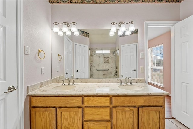 bathroom with walk in shower, vanity, and tile patterned flooring