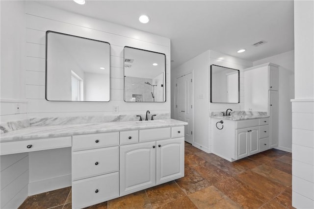 full bathroom with recessed lighting, two vanities, visible vents, and walk in shower