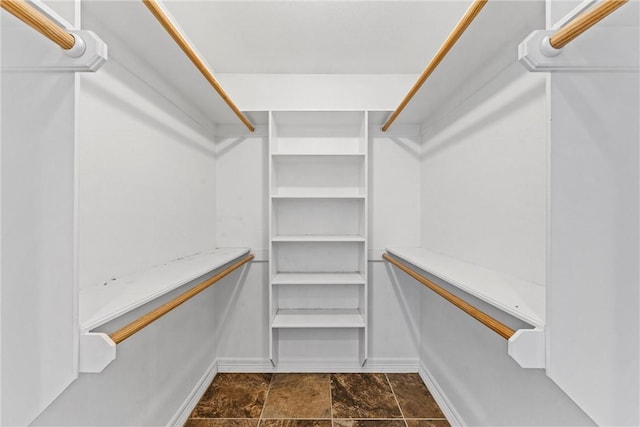 spacious closet with stone finish floor