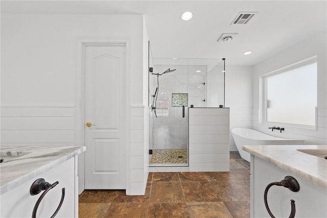 full bathroom with a freestanding bath, a stall shower, vanity, and visible vents